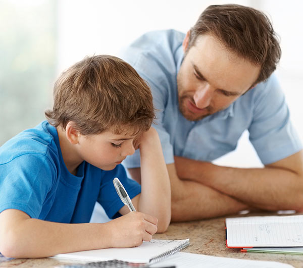 Father Helping Son With Schoolwork